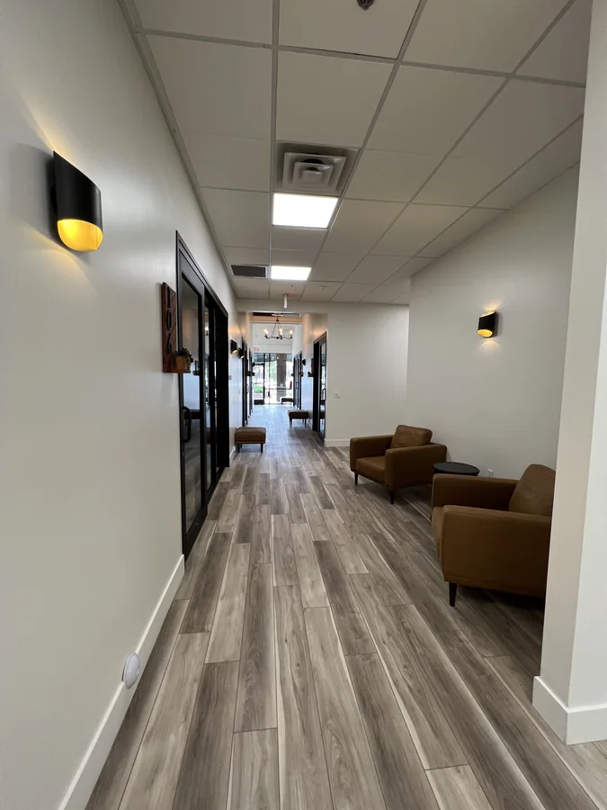 Bloom Hair Salon: Finished Bloom Hair Salon corridor with glass-front suites and lounge seating