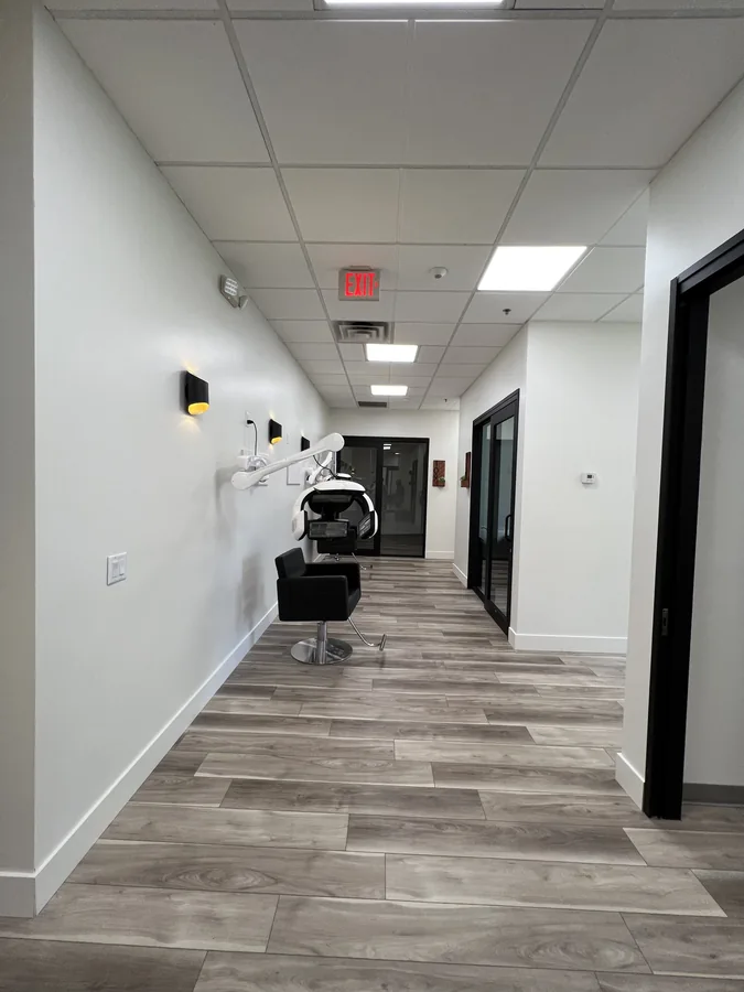 Bloom Hair Salon: Bloom Hair Salon suite corridor with styling chair and dryer